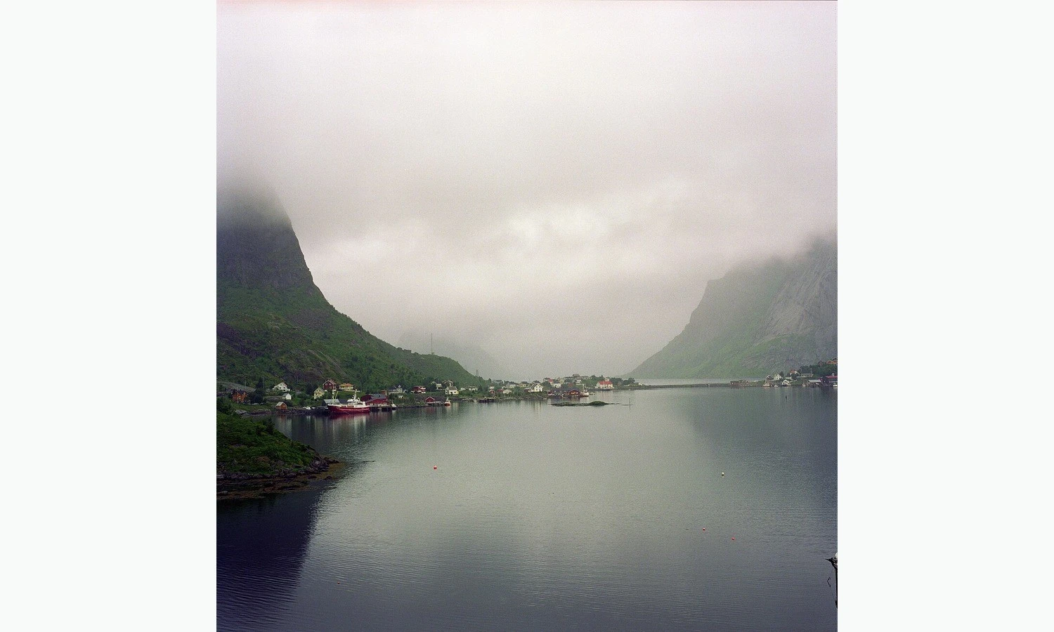 The village of Reine surrounded by mountains and red fishermen’s houses in the Lofoten Islands